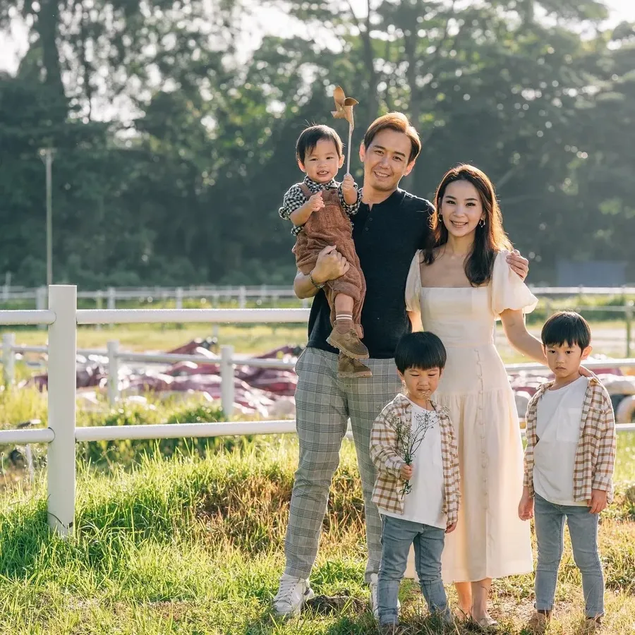 Family standing together in front of their home